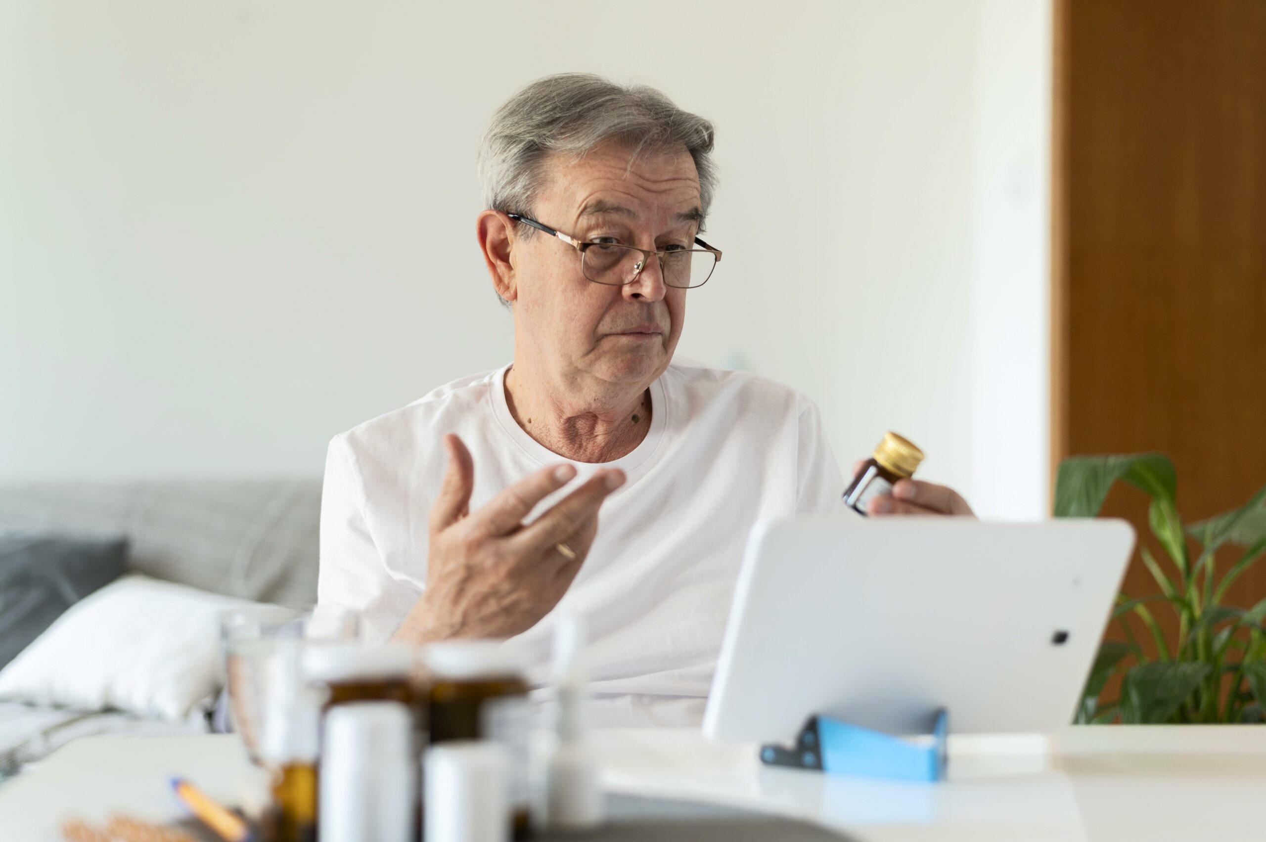 Man having an online consultation via Ibis, discussing medications with a doctor.